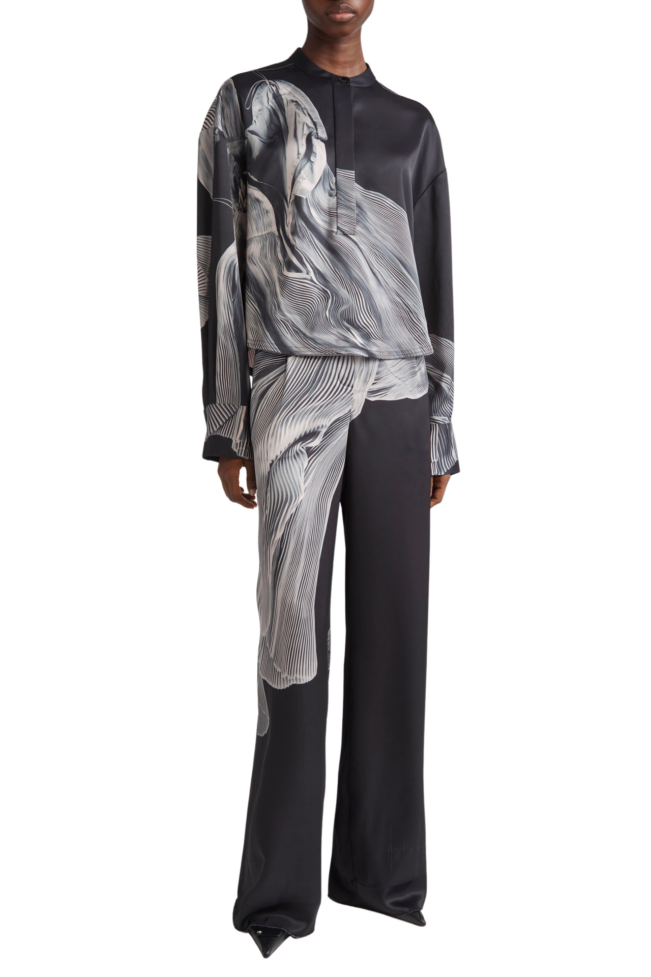 Person wearing a black and gray patterned outfit on a white background view 1