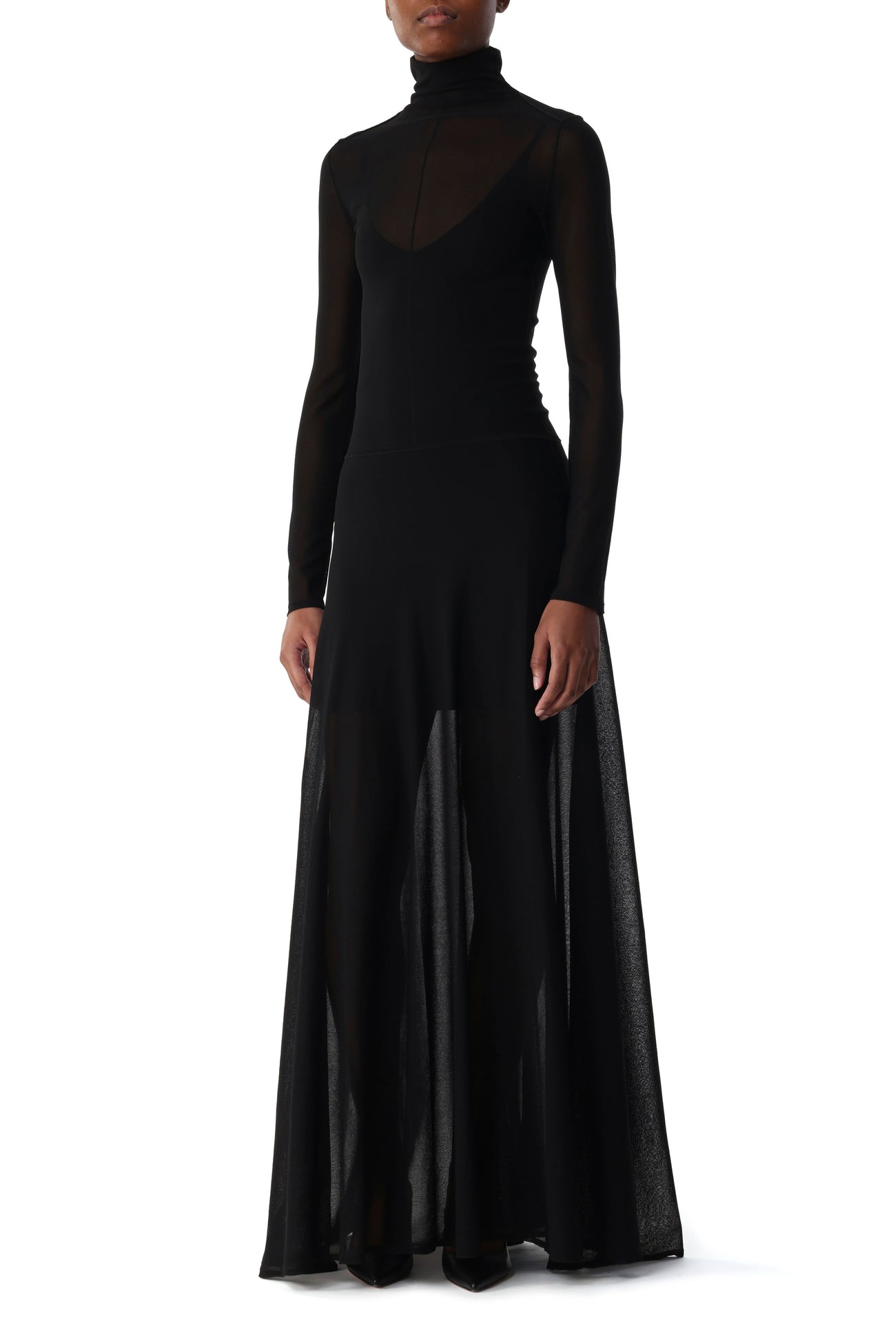 Model wearing a sheer, form-fitting knit dress with a high turtleneck, long sleeves, and deep V-neckline with mesh overlay. view 1