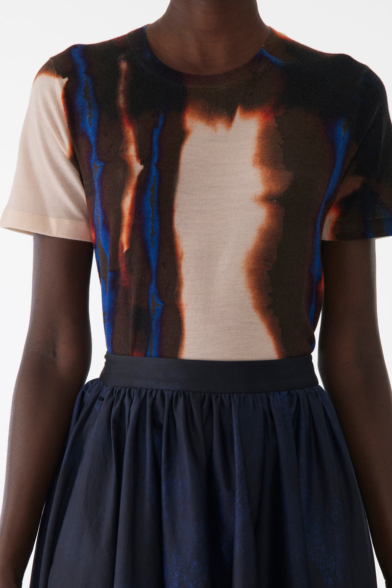 Model wearing a form-fitting short sleeve sweater in soft wool with a tonal burned stripe texture view 4