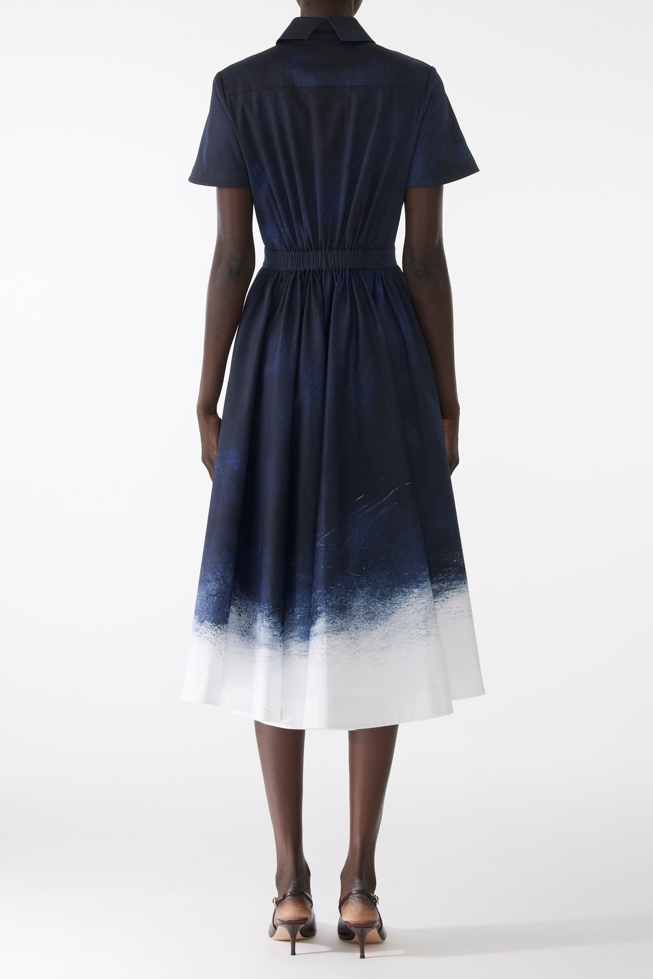 Model wearing a stretch cotton shirtdress with navy-and-white smudged print, featuring a tailored fit, button front, and soft brushed texture view 3