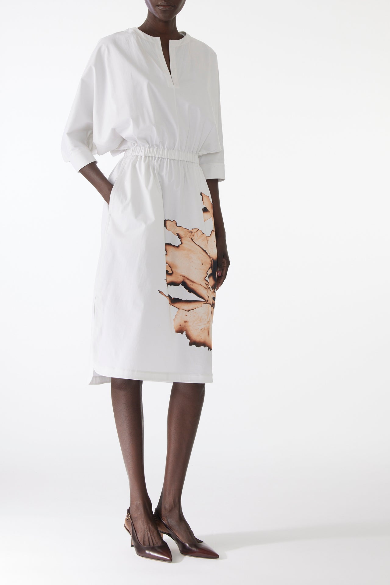 Model wearing cotton dress with dolman sleeves and an allover floral print, featuring a relaxed fit and softly structured silhouette. view 2