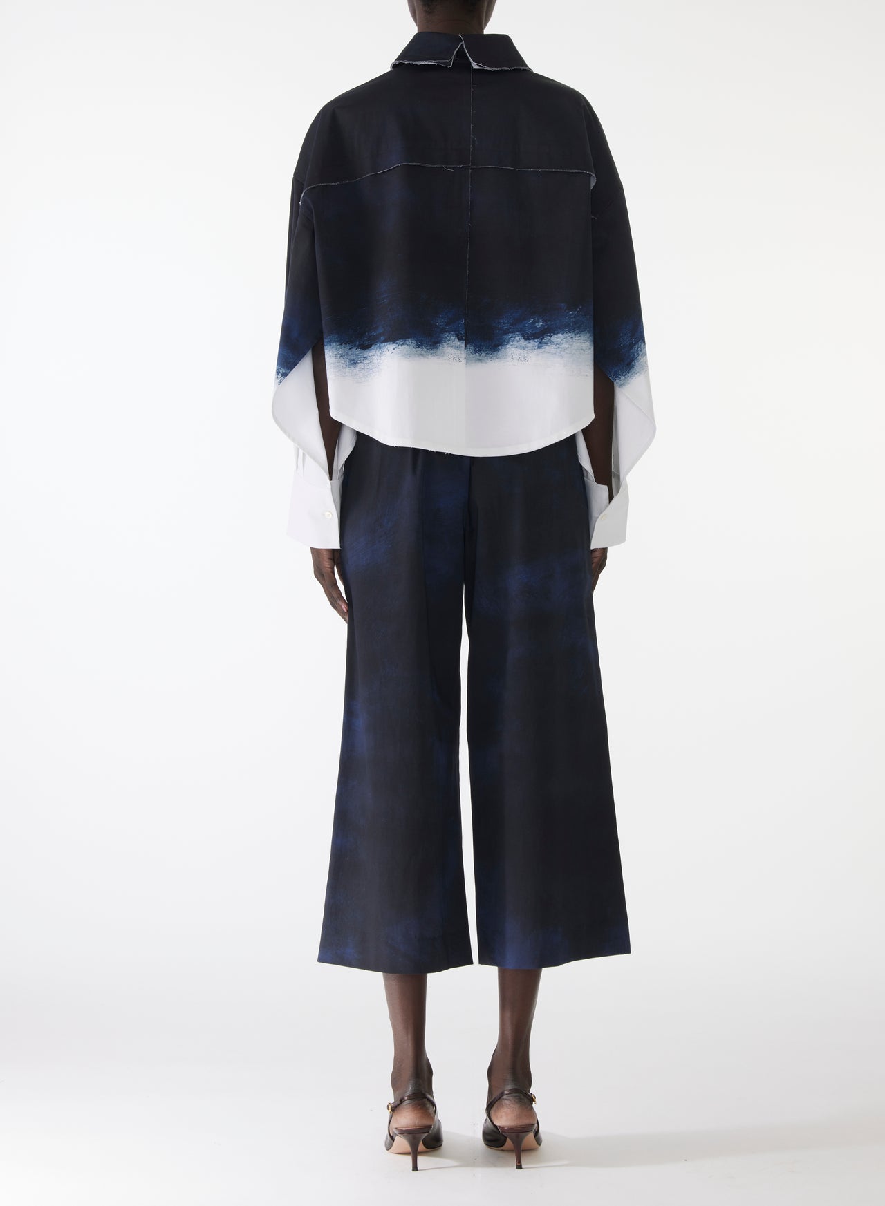 Model wearing wide-leg stretch cotton pants with elastic waistband and navy-and-white smudged print, styled with matching pop-over shirt. view 3
