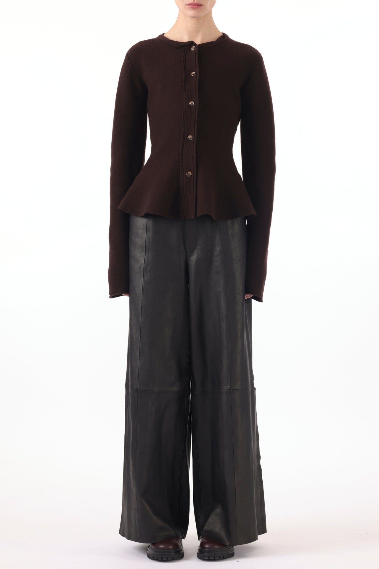 Model wearing a boiled wool cardigan with a peplum design, styled for a cozy, chic look. view 2