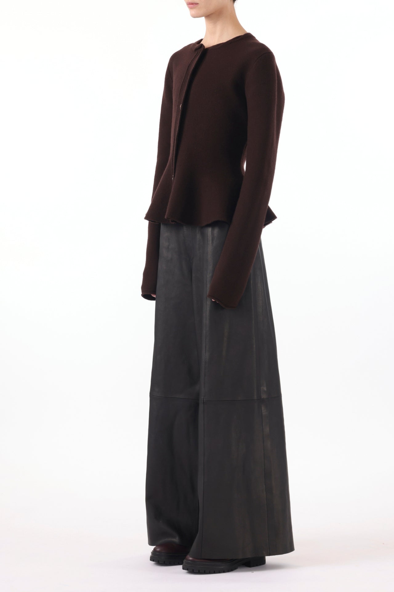 Model wearing a boiled wool cardigan with a peplum design, styled for a cozy, chic look. view 3