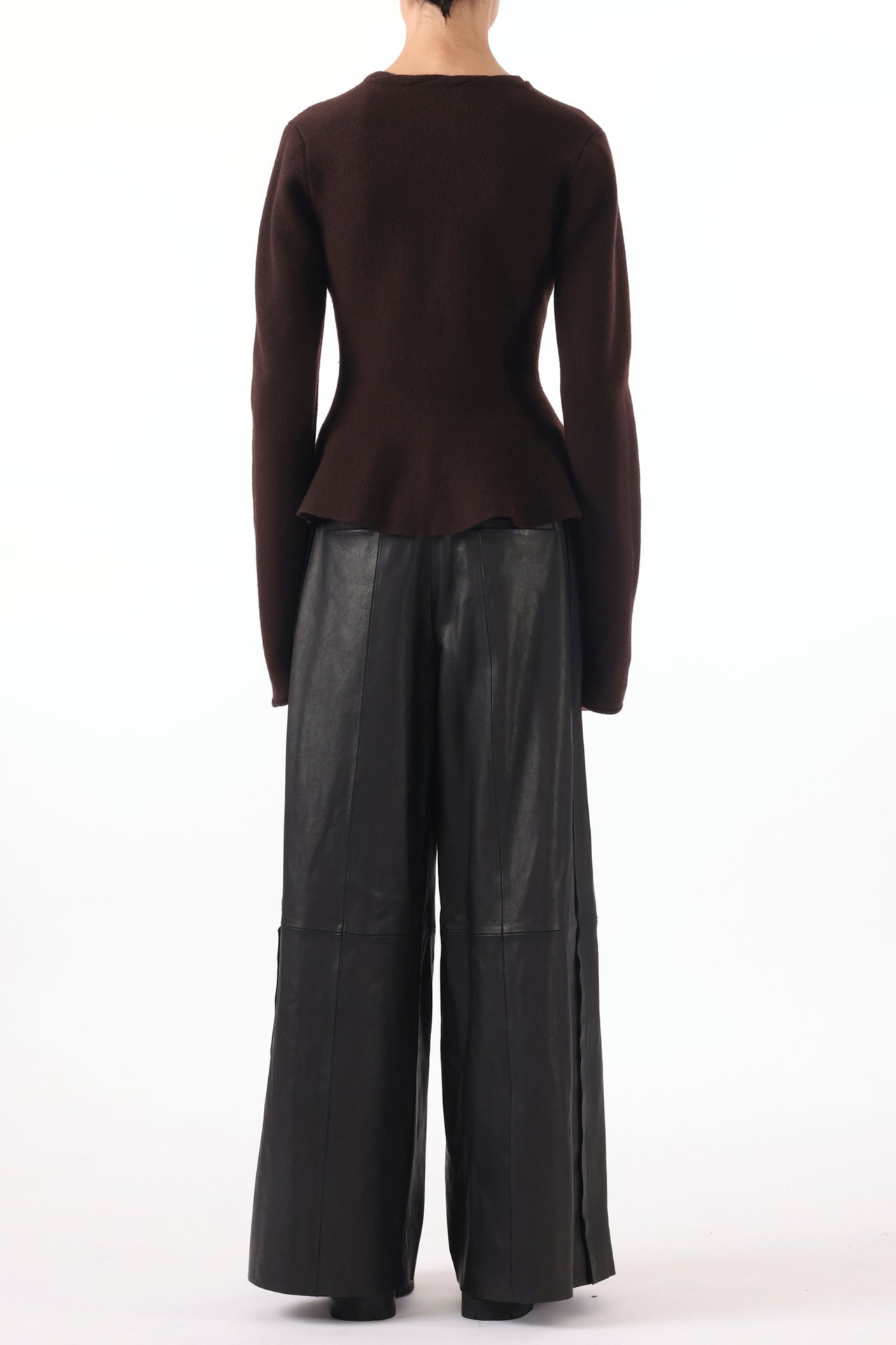 Model wearing a boiled wool cardigan with a peplum design, styled for a cozy, chic look. view 4