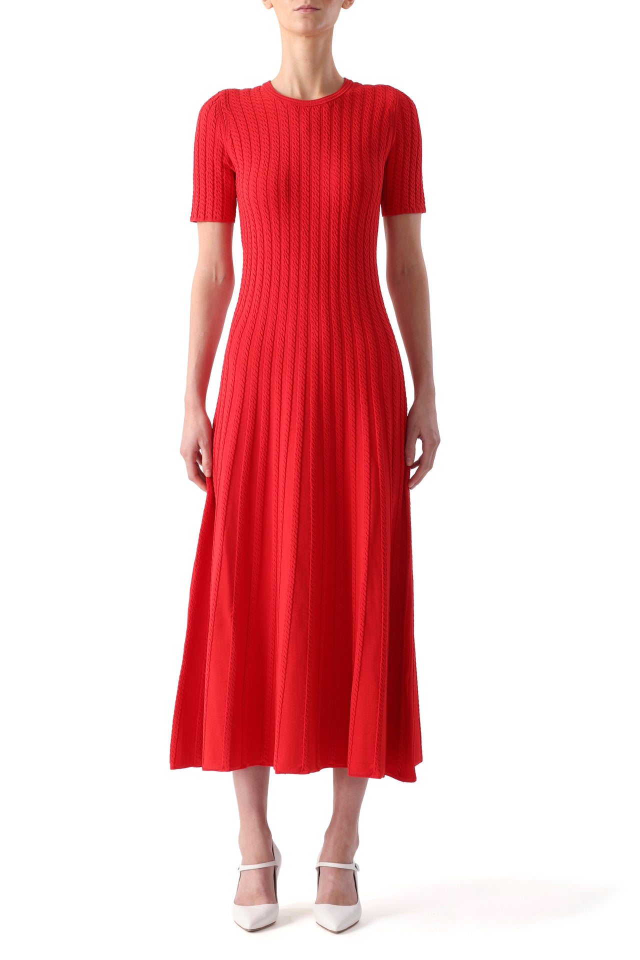 Model wearing a papaya short sleeve midi dress with cable stitching and a softly flared silhouette. view 1