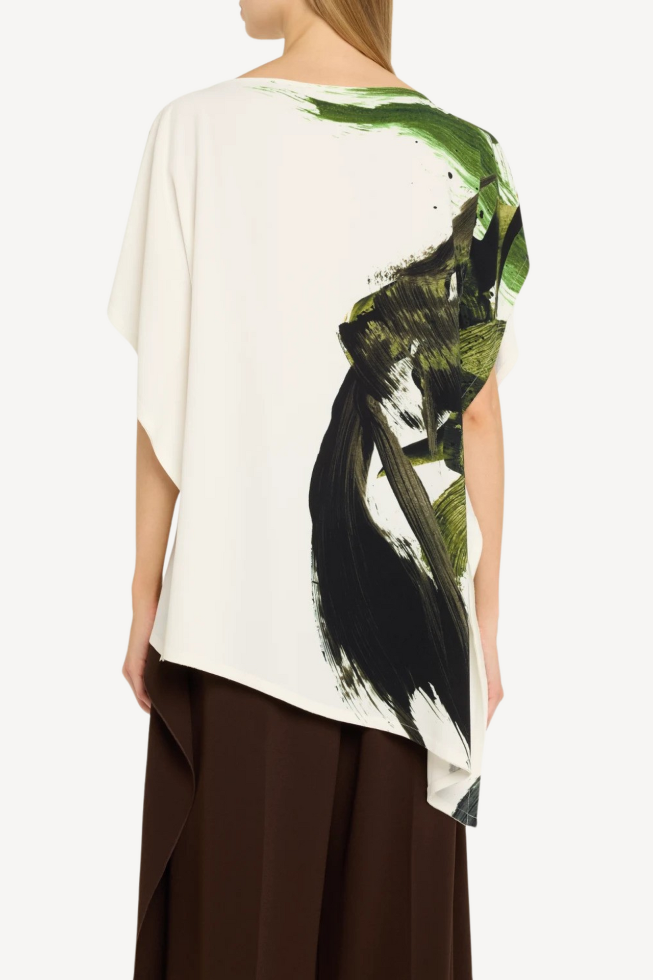 Model wearing an asymmetrical brushstroke printed crepe boatneck top with artistic flair. view 2