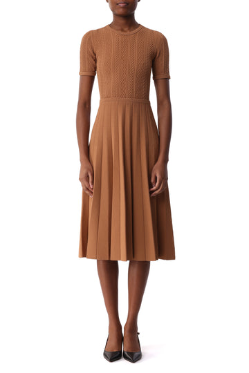 Model wearing a camel brown short sleeve cable knit midi dress with a fitted waist and pleated skirt. view 1