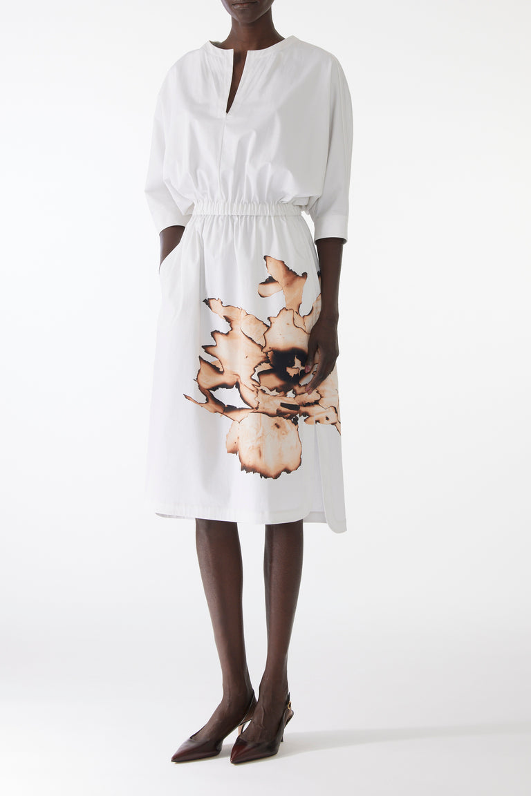 Model wearing cotton dress with dolman sleeves and an allover floral print, featuring a relaxed fit and softly structured silhouette. view 1