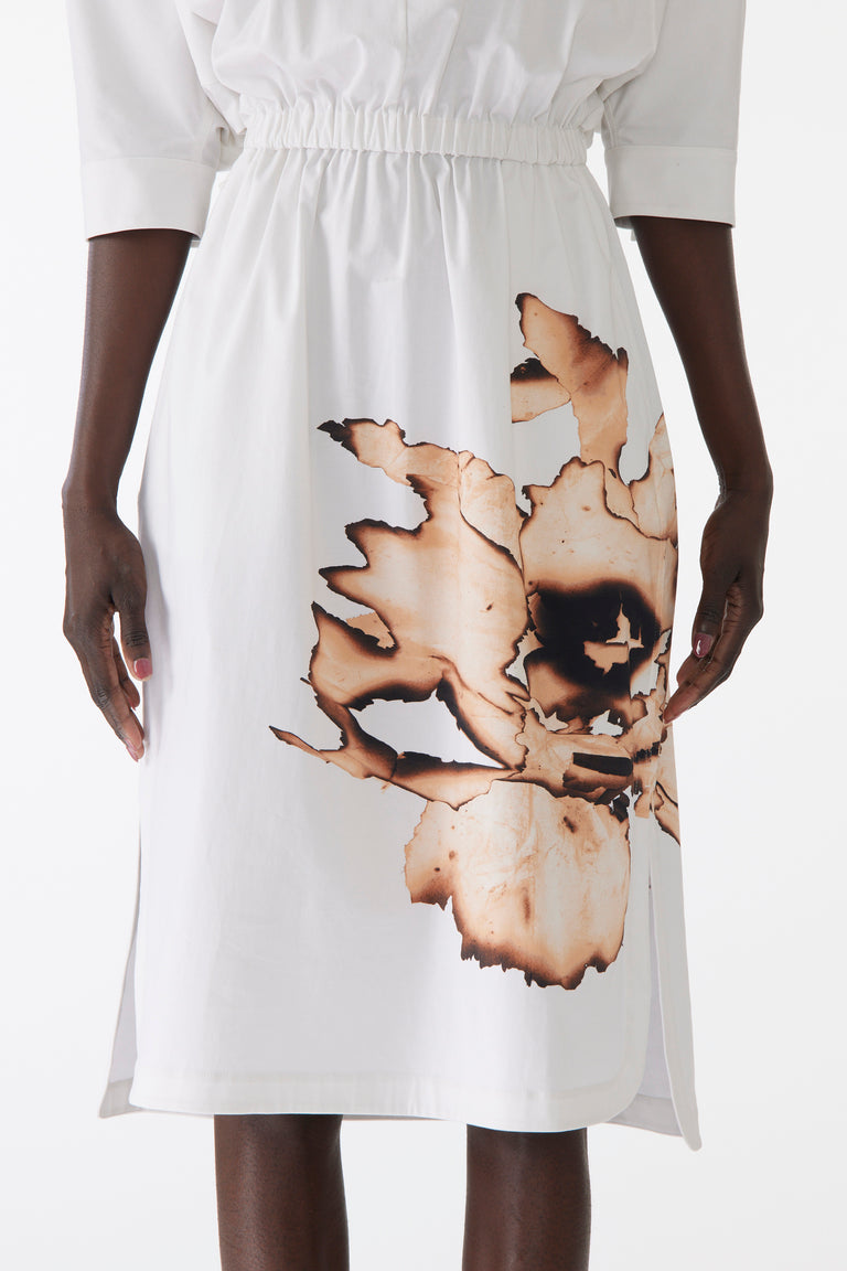 Model wearing cotton dress with dolman sleeves and an allover floral print, featuring a relaxed fit and softly structured silhouette. view 3