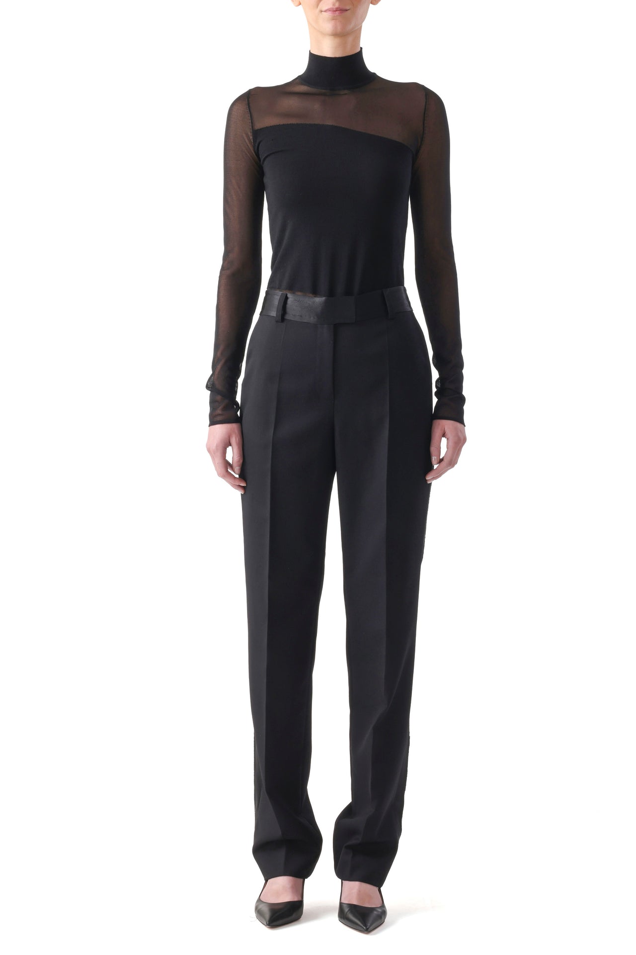 Model in a black merino knit turtleneck featuring sheer panels and long sleeves with a slim fit. view 1