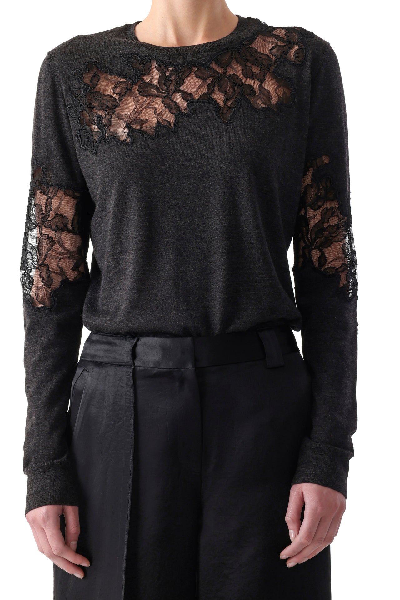 Model wearing a graphite merino crewneck sweater with lace accents at neckline and cuffs. view 1